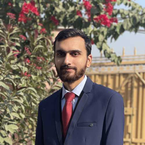 A picture of Saad Wasil wearing a navy blue three piece suit